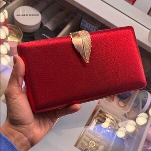 Elegant Red Clutch with Gold Leaf Accent